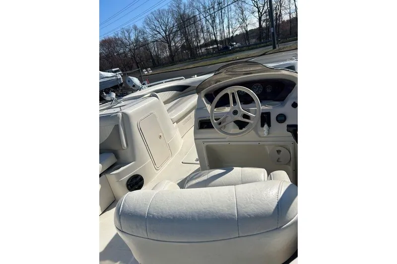 Slide: The Image of Interior view of a 2009 SouthWind 210 SD boat, featuring steering wheel and seating. - 5