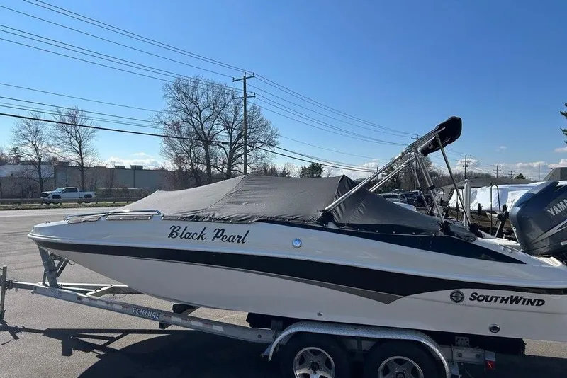 Slide: The Image of 2009 SouthWind 210 SD boat named "Black Pearl" on a trailer, parked outdoors. - 7