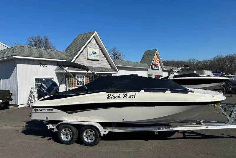 Slide: The Image of 2009 SouthWind 210 SD boat named "Black Pearl" on trailer outside dealership. - 9
