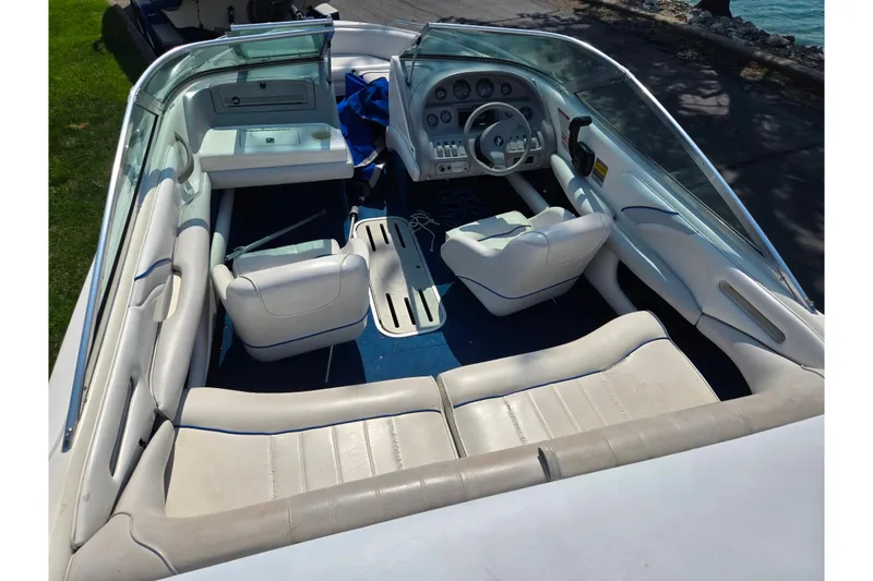 Slide: The Image of 1994 Sea Ray 180 Bow Rider interior with white seating and blue carpet. - 11