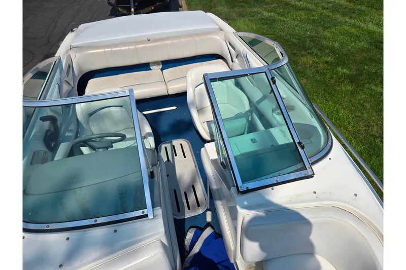 Slide: The Image of 1994 Sea Ray 180 Bow Rider boat interior with white seating and blue carpet. - 20