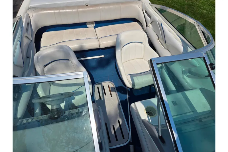 Slide: The Image of 1994 Sea Ray 180 Bow Rider interior with white seating and blue flooring. - 21