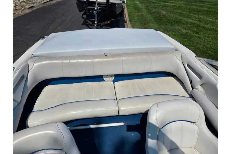 Slide: The Image of 1994 Sea Ray 180 Bow Rider interior with white seating and blue accents. - 22