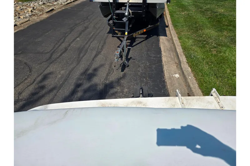 Slide: The Image of 1994 Sea Ray 180 Bow Rider on trailer, parked on asphalt road. - 25