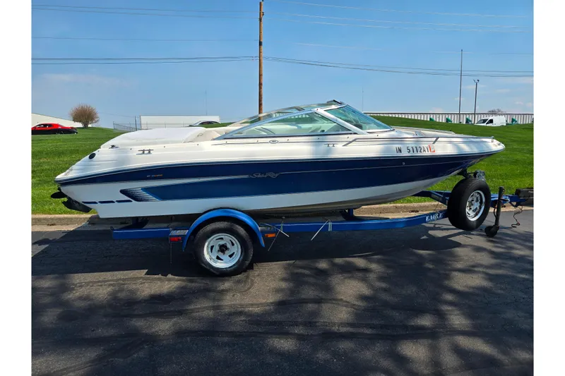 Slide: The Image of 1994 Sea Ray 180 Bow Rider boat on trailer, parked outdoors. - 5