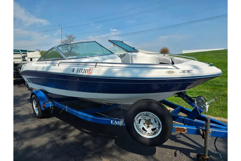 Slide: The Image of 1994 Sea Ray 180 Bow Rider boat on trailer, parked outdoors. - 6