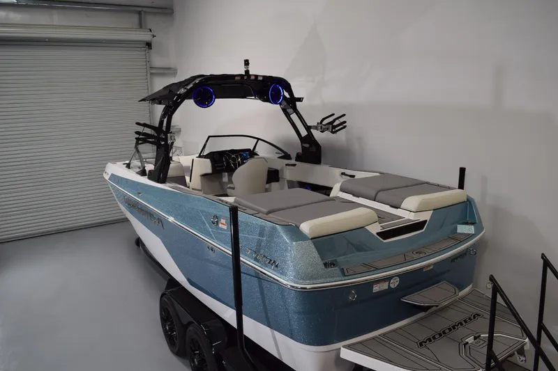 Slide: The Image of 2026 Moomba Tykon boat in showroom, featuring sleek design and modern amenities. - 10