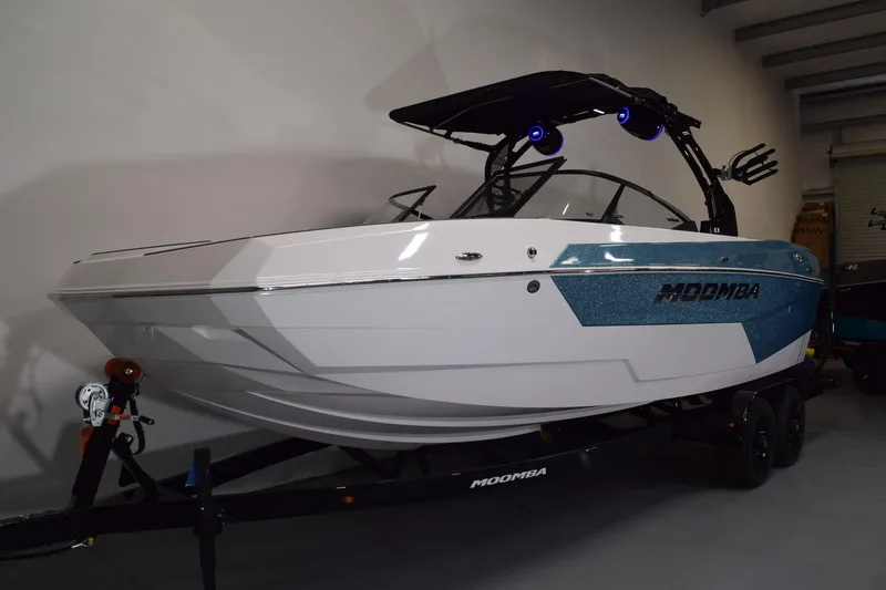 Slide: The Image of 2026 Moomba Tykon boat in showroom, featuring sleek design and modern features. - 2