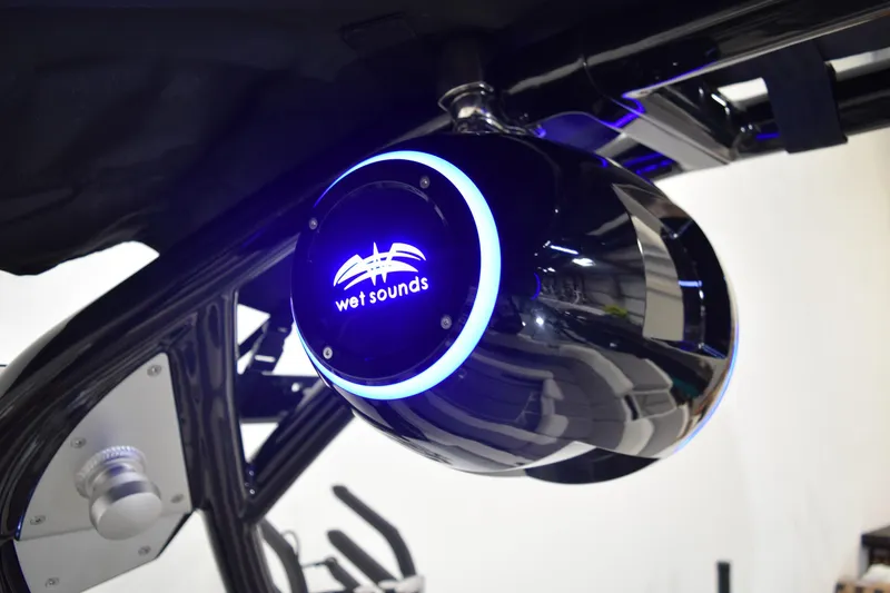 Slide: The Image of 2026 Moomba Tykon boat with Wet Sounds speaker, featuring sleek black design and blue LED lighting. - 25