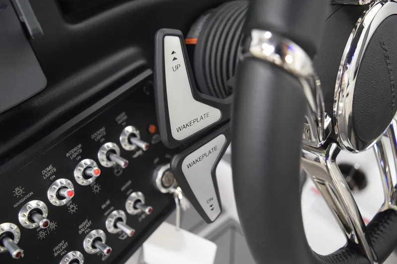 Slide: The Image of 2026 Moomba Tykon boat dashboard with wakeplate controls and switches. - 29