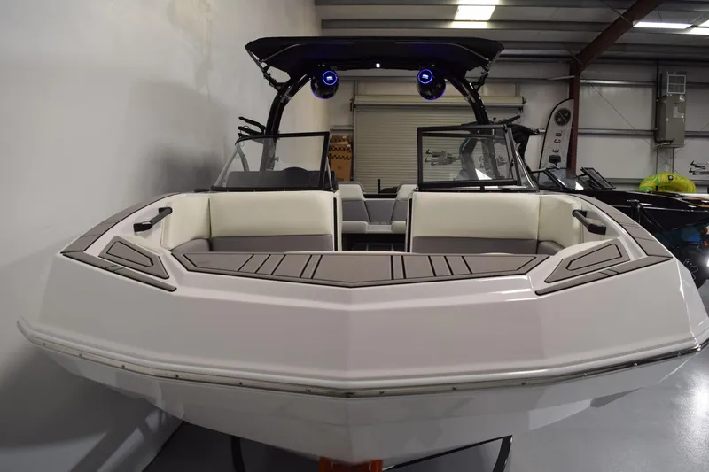 Slide: The Image of 2026 Moomba Tykon boat with sleek design and modern features in a showroom setting. - 3