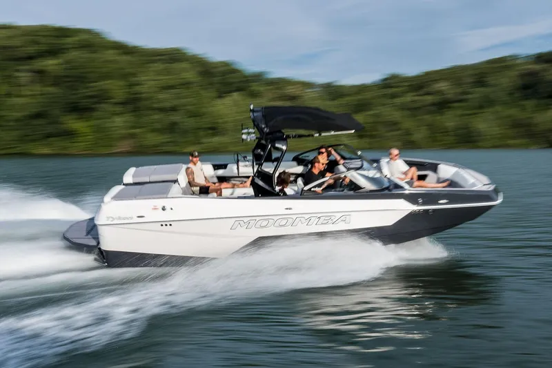 Slide: The Image of Manufacturer Provided Image: 2026 Moomba Tykon speedboat cruising on a lake with passengers, surrounded by lush greenery. - 35