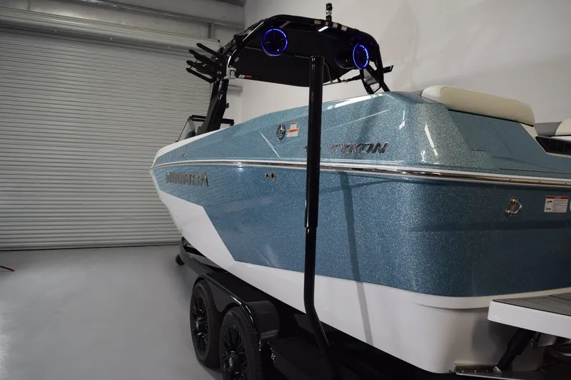 Slide: The Image of 2026 Moomba Tykon boat in showroom, featuring sleek blue design and modern detailing. - 4