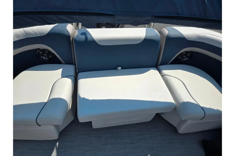 Slide: The Image of 2025 Godfrey Sweetwater 2286 QS boat interior with cushioned seating and speakers. - 18