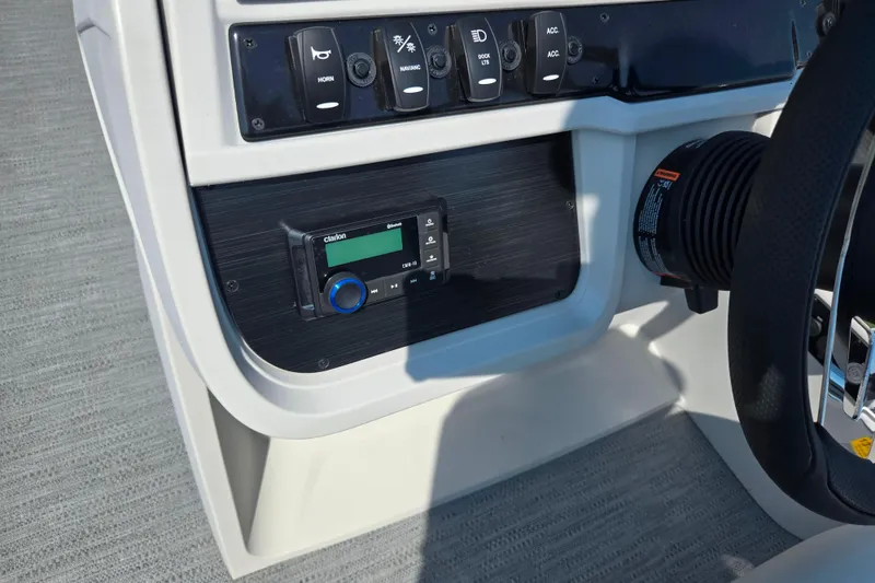 Slide: The Image of 2025 Godfrey Sweetwater 2286 QS dashboard with controls and Clarion audio system. - 22