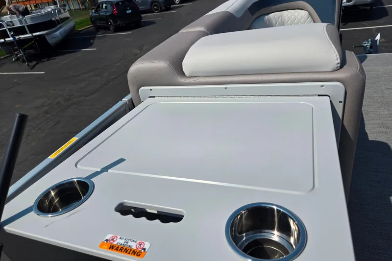 Slide: The Image of 2025 Godfrey Sweetwater 2286 QS boat interior with cup holders and seating. - 24