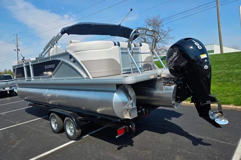 Slide: The Image of 2025 Godfrey Sweetwater 2286 QS pontoon boat on trailer, featuring Mercury outboard motor. - 3