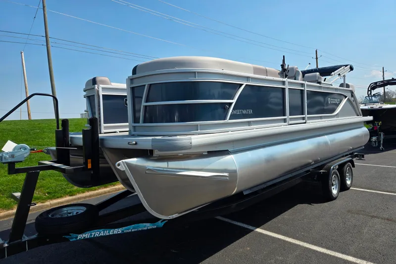Slide: The Image of 2025 Godfrey Sweetwater 2286 QS pontoon boat on trailer in parking lot. - 5