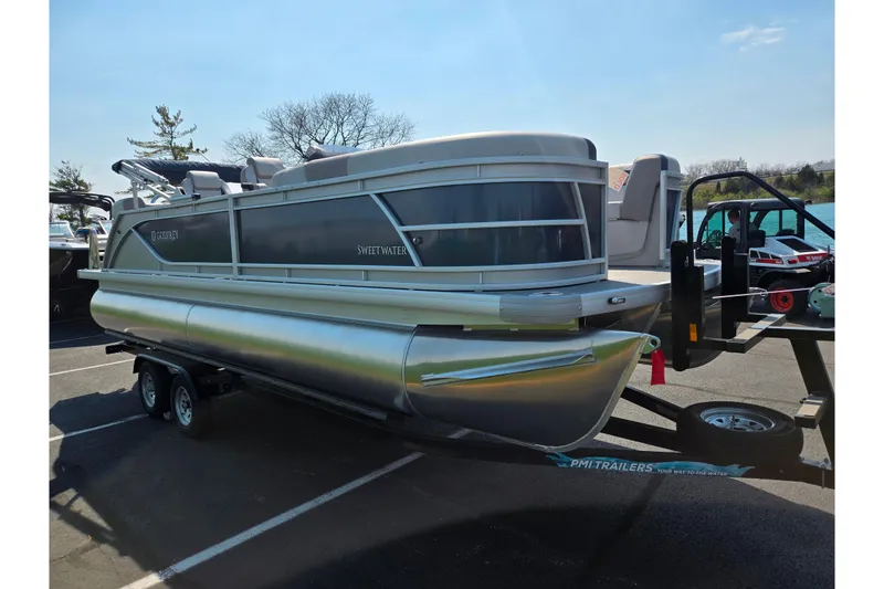 Slide: The Image of 2025 Godfrey Sweetwater 2286 QS pontoon boat on trailer in parking lot. - 8