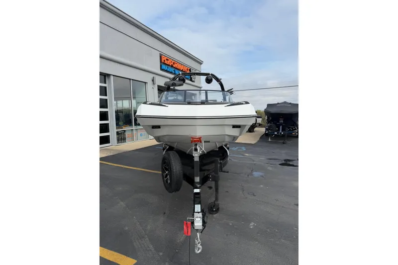 Slide: The Image of 2026 Moomba Tykon boat on trailer at Performance Marine dealership. - 11