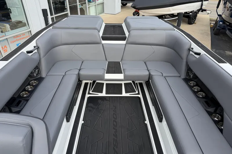 Slide: The Image of 2026 Moomba Tykon boat interior with gray seating and cup holders. - 13