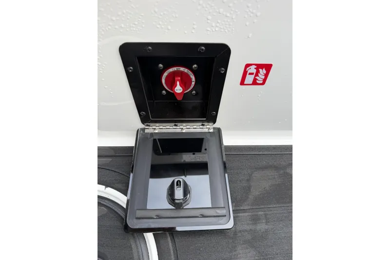 Slide: The Image of 2026 Moomba Tykon boat battery switch and fire extinguisher symbol on deck. - 17