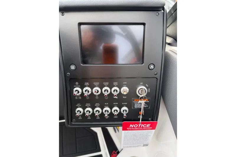 Slide: The Image of Control panel of 2026 Moomba Tykon boat with switches and ignition key. - 20