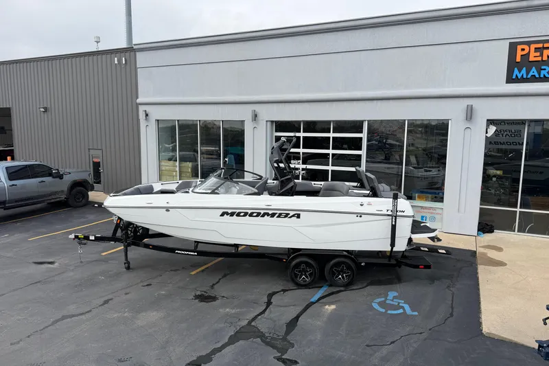 Slide: The Image of 2026 Moomba Tykon boat on trailer outside dealership. - 3