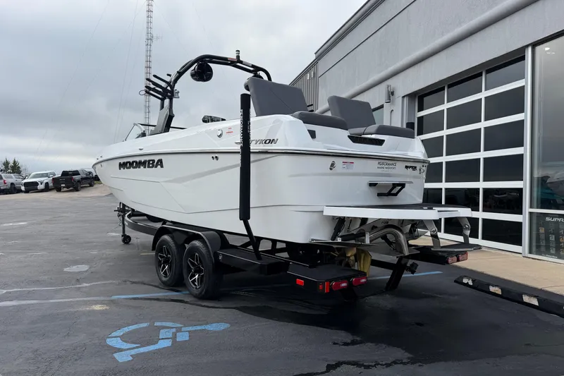 Slide: The Image of 2026 Moomba Tykon boat on trailer outside dealership, overcast sky. - 4