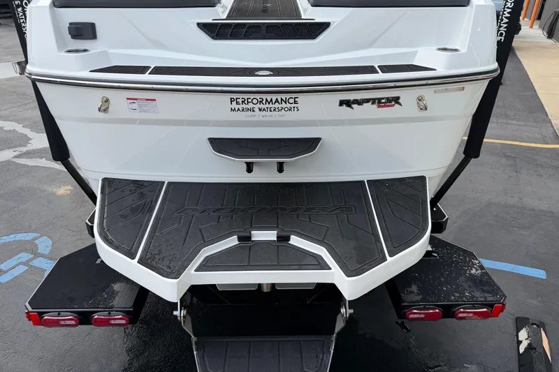 Slide: The Image of 2026 Moomba Tykon boat rear view with Performance Marine Watersports branding. - 6