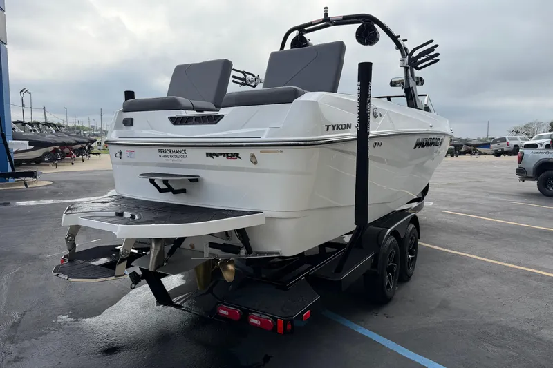 Slide: The Image of 2026 Moomba Tykon boat on trailer, parked in a marina lot. - 8