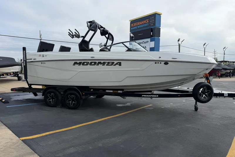 Slide: The Image of 2026 Moomba Tykon boat on trailer at dealership parking lot. - 9