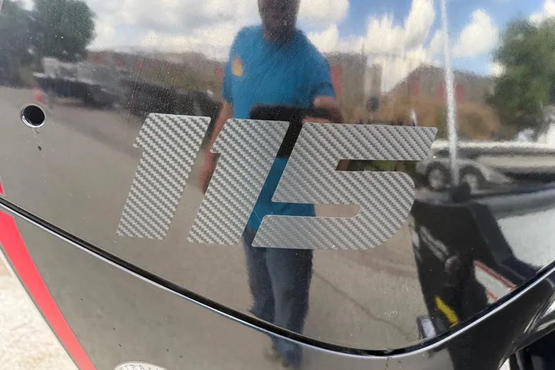 Slide: The Image of "115" decal on 2020 Tracker Pro Team 190 TX boat, reflecting surroundings. - 12