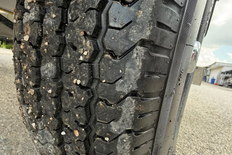 Slide: The Image of Close-up of a 2020 Tracker Pro Team 190 TX tire with gravel embedded in the tread. - 16