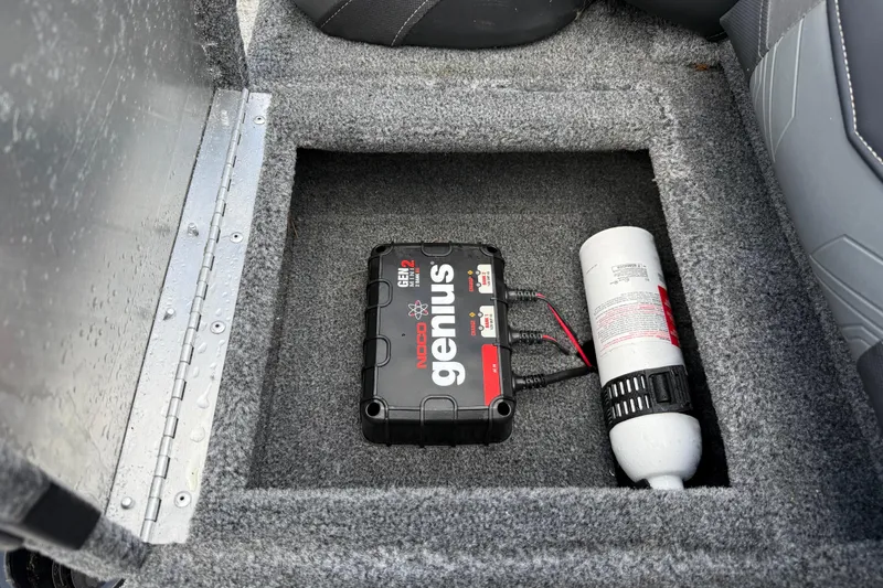 Slide: The Image of 2020 Tracker Pro Team 190 TX boat compartment with NOCO Genius charger and fire extinguisher. - 20