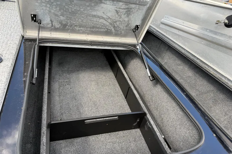 Slide: The Image of Open storage compartment in a 2020 Tracker Pro Team 190 TX boat. - 31