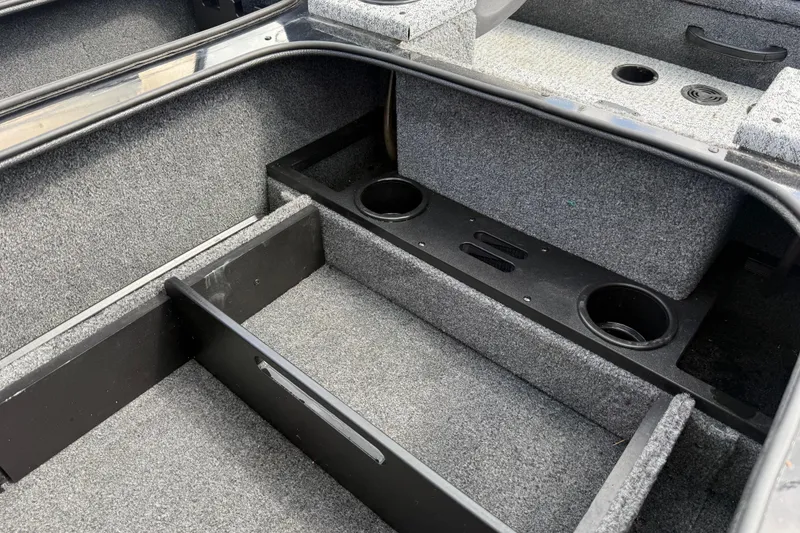 Slide: The Image of Interior of 2020 Tracker Pro Team 190 TX boat with carpeted storage compartments. - 32