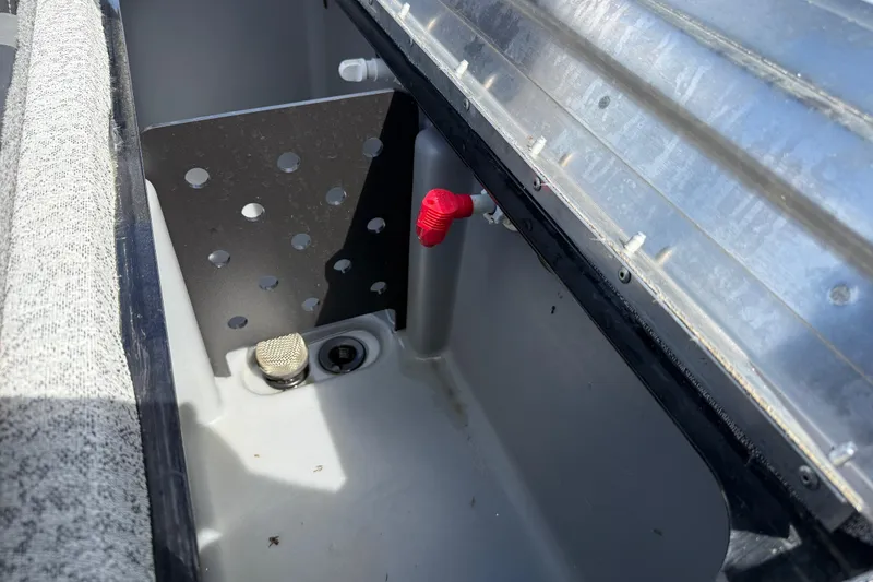 Slide: The Image of 2020 Tracker Pro Team 190 TX boat compartment with red valve and drainage system. - 36