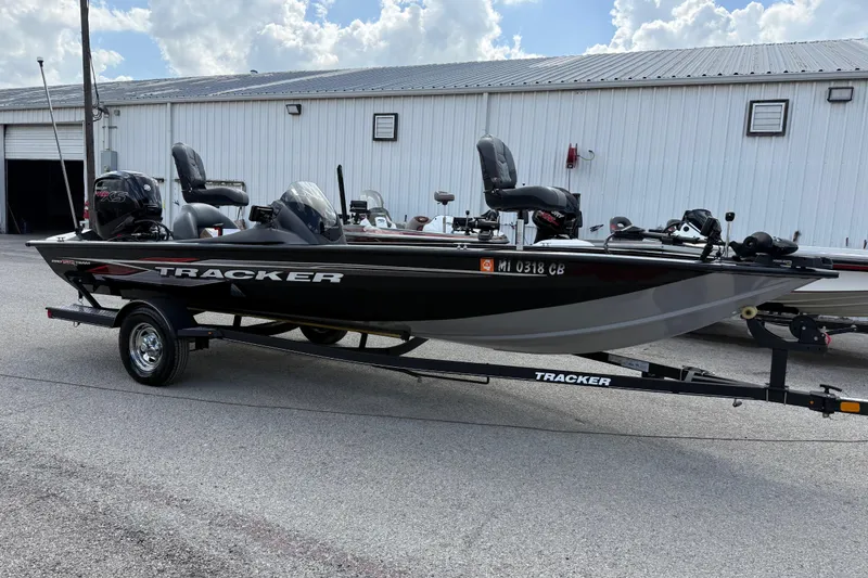 Slide: The Image of 2020 Tracker Pro Team 190 TX boat on trailer, parked outside a warehouse. - 4