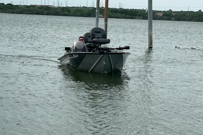 Slide: The Image of 2020 Tracker Pro Team 190 TX boat on a calm lake with distant trees. - 43