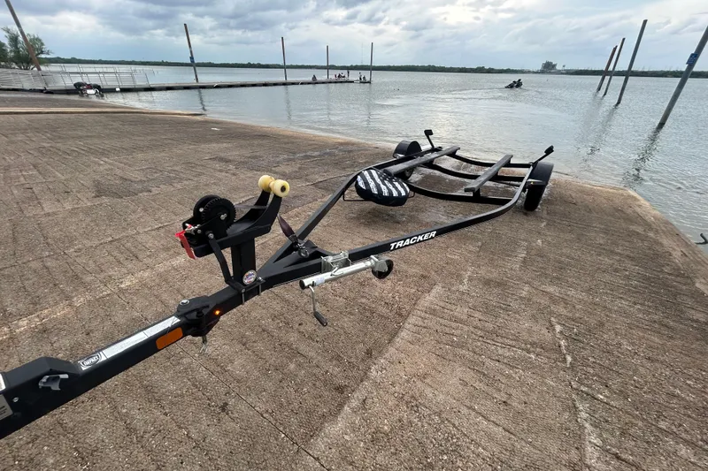 Slide: The Image of Boat trailer for 2020 Tracker Pro Team 190 TX at lakeside ramp. - 48