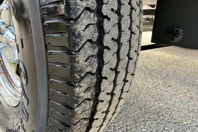 Slide: The Image of Close-up of a 2020 Tracker Pro Team 190 TX trailer tire on asphalt. - 5