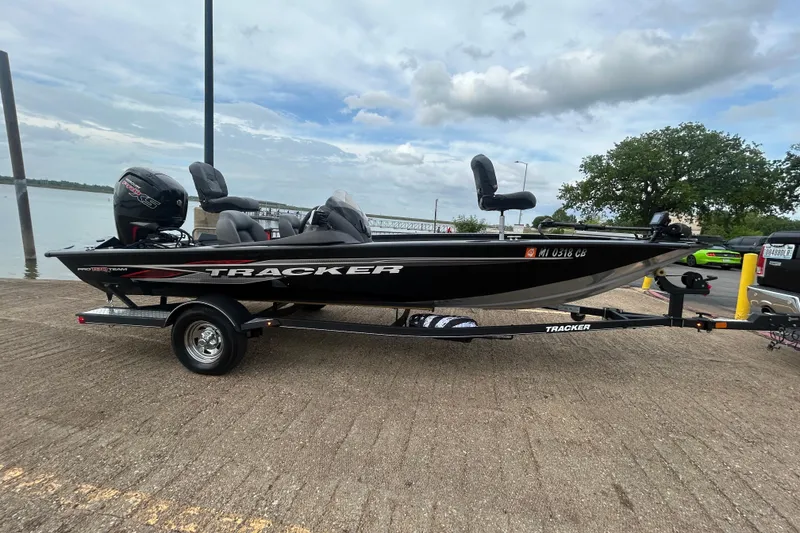 Slide: The Image of 2020 Tracker Pro Team 190 TX boat on trailer by a lake, under cloudy sky. - 53