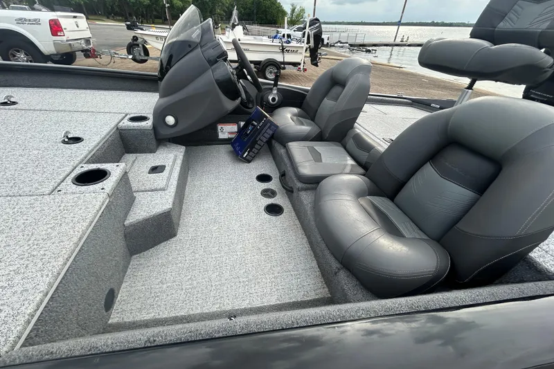 Slide: The Image of 2020 Tracker Pro Team 190 TX boat interior with gray seating and steering console. - 62