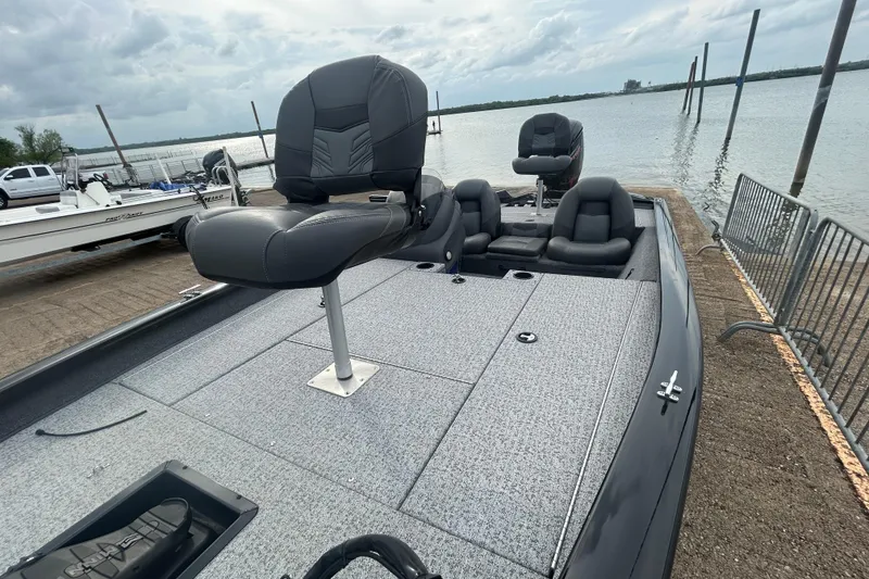 Slide: The Image of 2020 Tracker Pro Team 190 TX boat docked by a lake under cloudy skies. - 65
