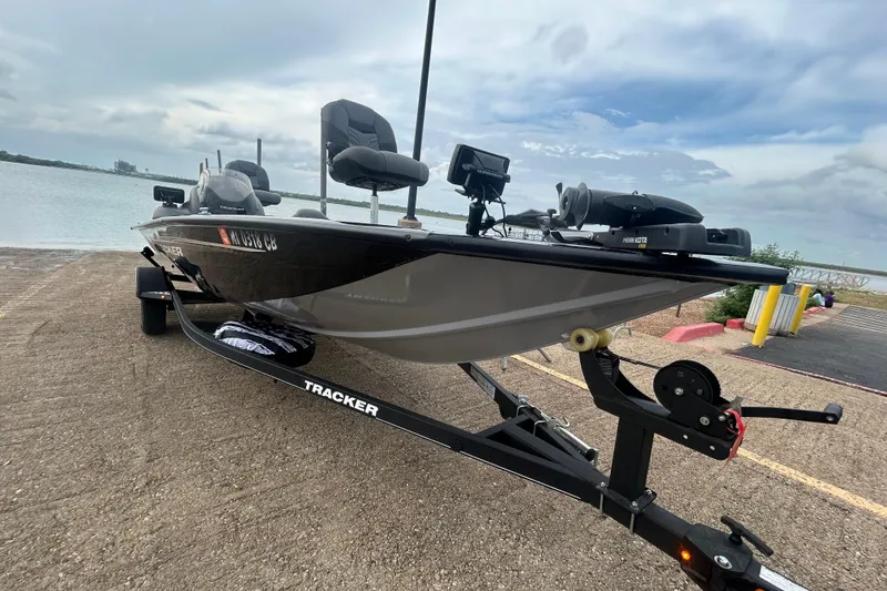 Slide: The Image of 2020 Tracker Pro Team 190 TX boat on trailer by waterfront under cloudy sky. - 66