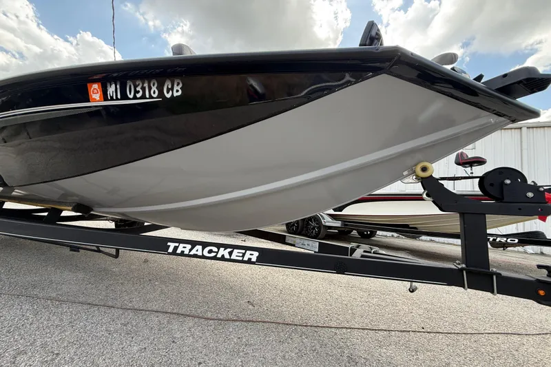 Slide: The Image of 2020 Tracker Pro Team 190 TX boat on trailer, parked outdoors under cloudy sky. - 9