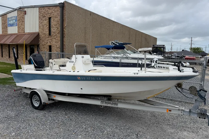The Image of 2006 NAUTIC STAR 2100 boat on trailer, parked outside a dealership. - 1