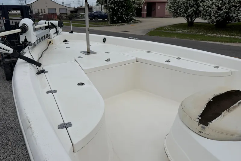 Slide: The Image of 2006 NAUTIC STAR 2100 boat interior with seating and equipment, parked outdoors. - 10