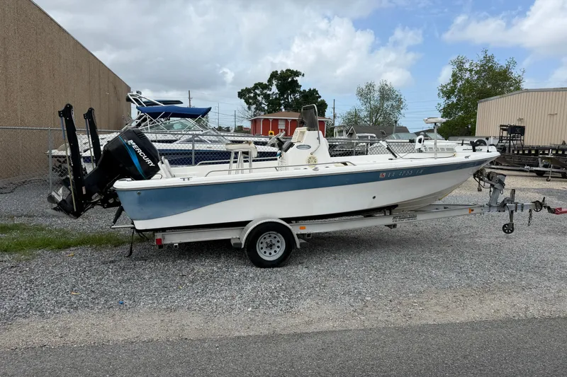 Slide: The Image of 2006 NAUTIC STAR 2100 boat on trailer with Mercury outboard motor. - 2